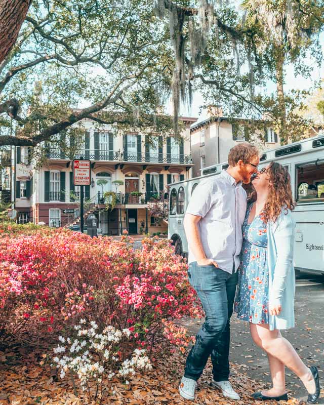 Lia and Jeremy, founders of Bourbon City Trolley, in front of a trolley in Savannah Georgia